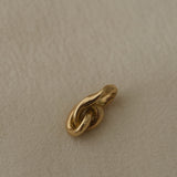 Handcrafted 18k recycled gold pendant from Basel, Switzerland with an organic design, featuring a shiny surface.