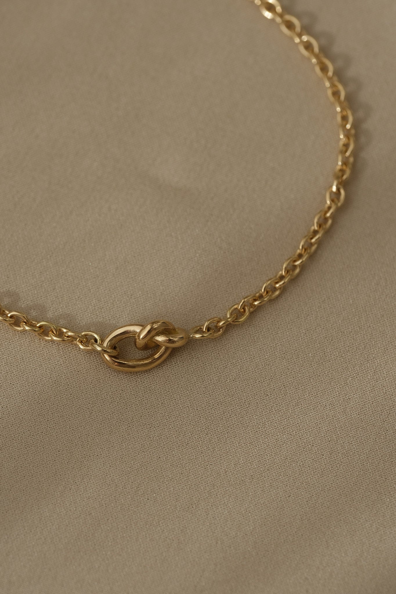 Close-up of a handcrafted 18k recycled gold bracelet with a natural shiny surface, designed and polished in Basel Switzerland.