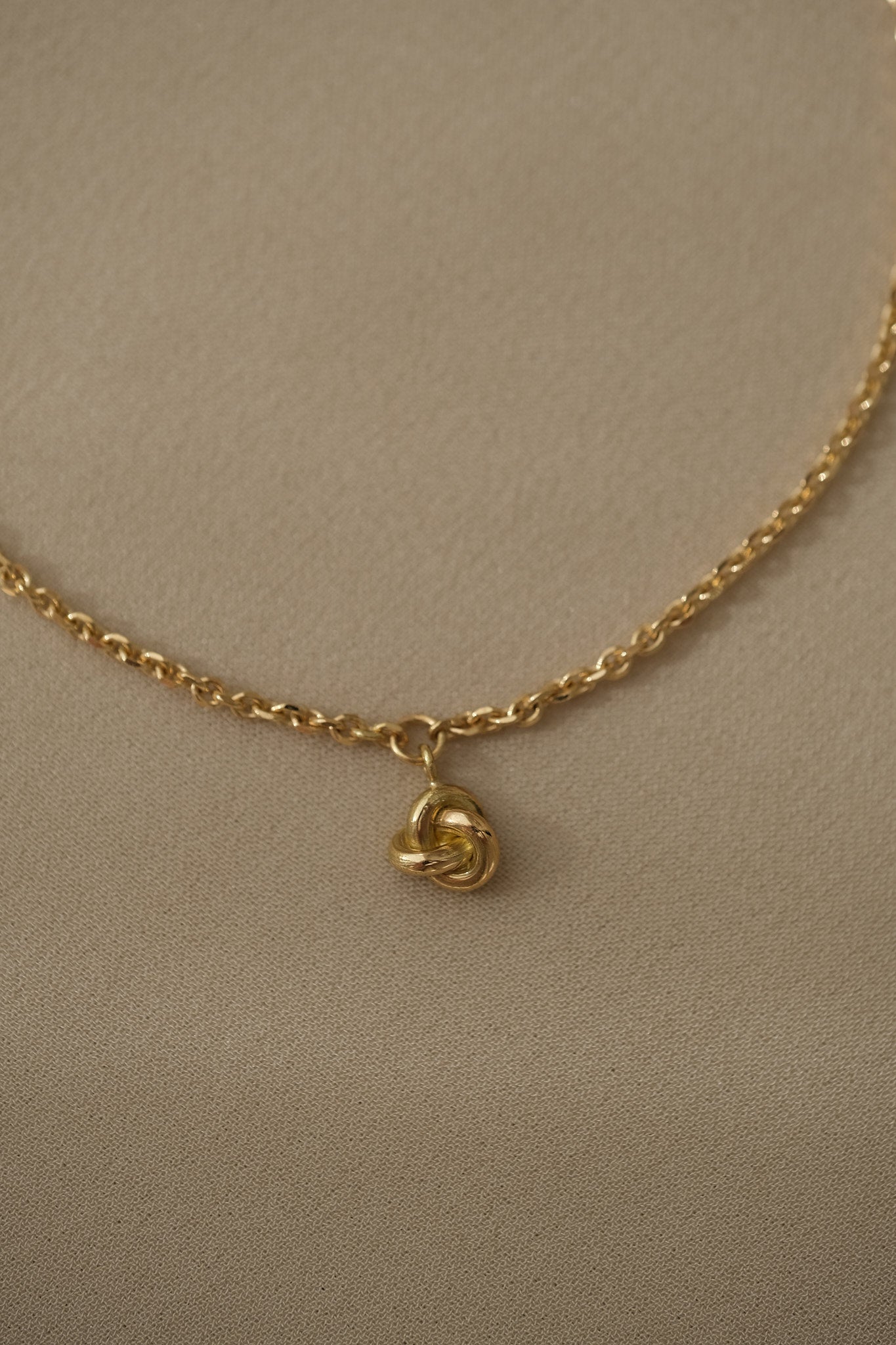 Handcrafted 18k recycled gold bracelet with a charm, designed in Basel, Switzerland, featuring a natural shiny surface.