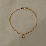 18k recycled gold bracelet with charm, handcrafted in Basel Switzerland, featuring a natural shiny surface.