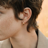 Hoops made of recycled 18k gold worn by a model in Basel, showcasing sustainable jewelry design.