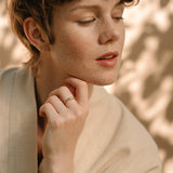 Model wearing AGAPI ring made of 18k recycled gold, showcasing sustainable luxury handcrafted in Basel, Switzerland.