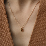 SINUOSA necklace in 18k recycled gold, handcrafted in Basel, Switzerland, featuring a delicate organic design.