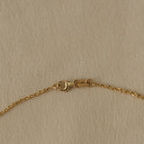 Close-up of 18k recycled gold chain clasp, handcrafted in Basel, Switzerland with organic design.