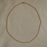 TRESSE Chain in 18k recycled gold, handcrafted in Basel, Switzerland, featuring a braided design.