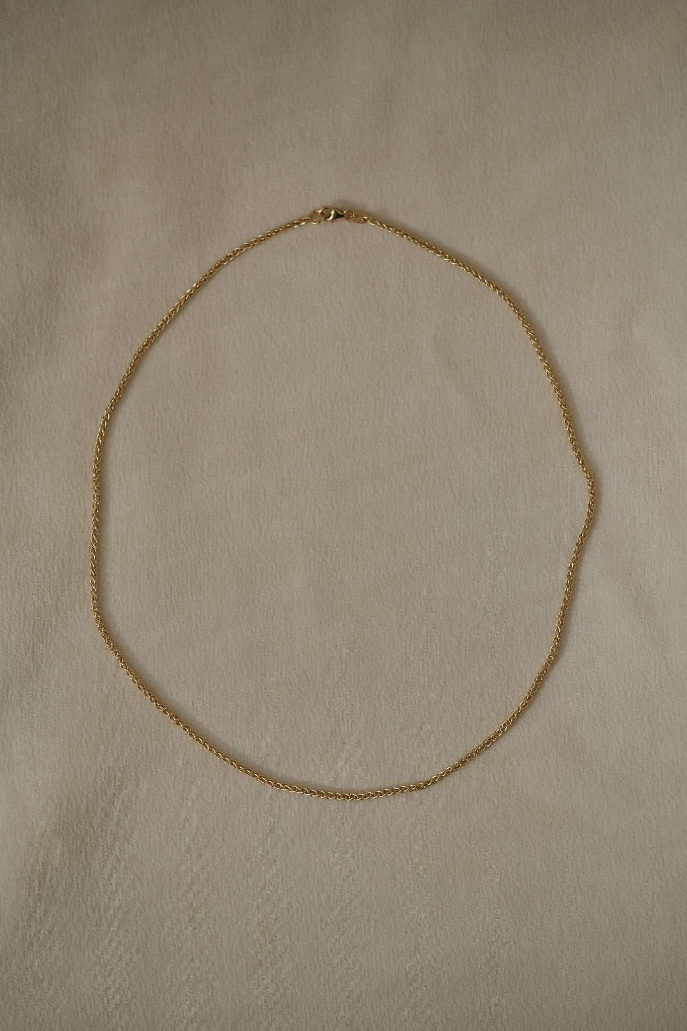 TRESSE Chain in 18k recycled gold, handcrafted in Basel, Switzerland, featuring a braided design.