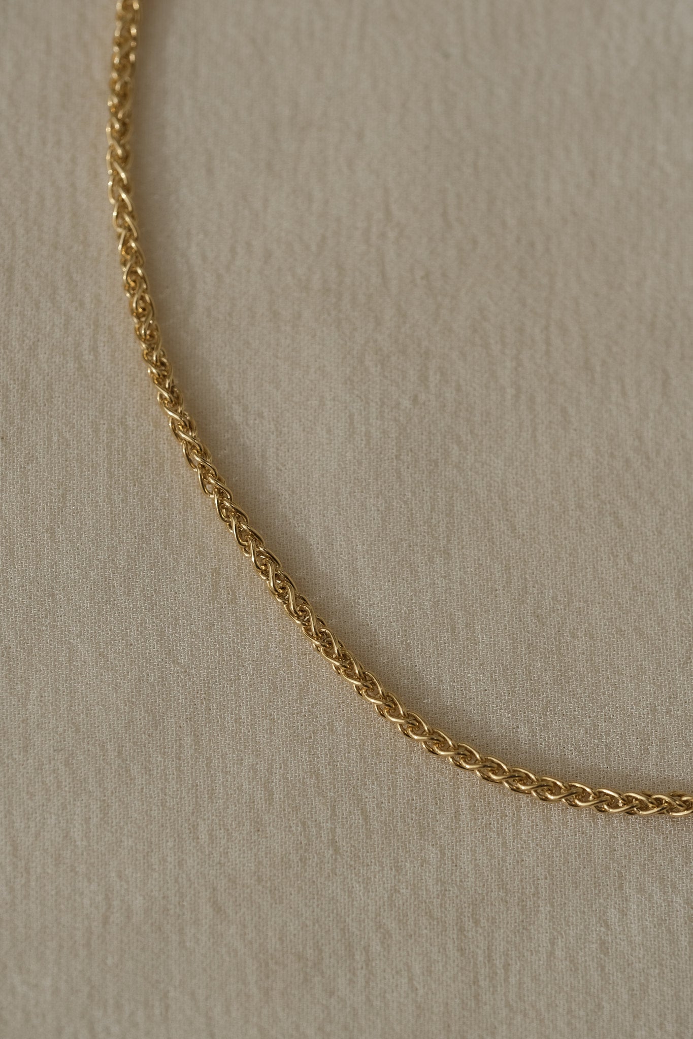 Braided TRESSE Chain made from 18k recycled gold, handcrafted in Basel, Switzerland. Elegant and organic design.