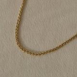 Handcrafted TRESSE chain in 18k recycled gold, designed in Basel, Switzerland, showcasing sustainable elegance.