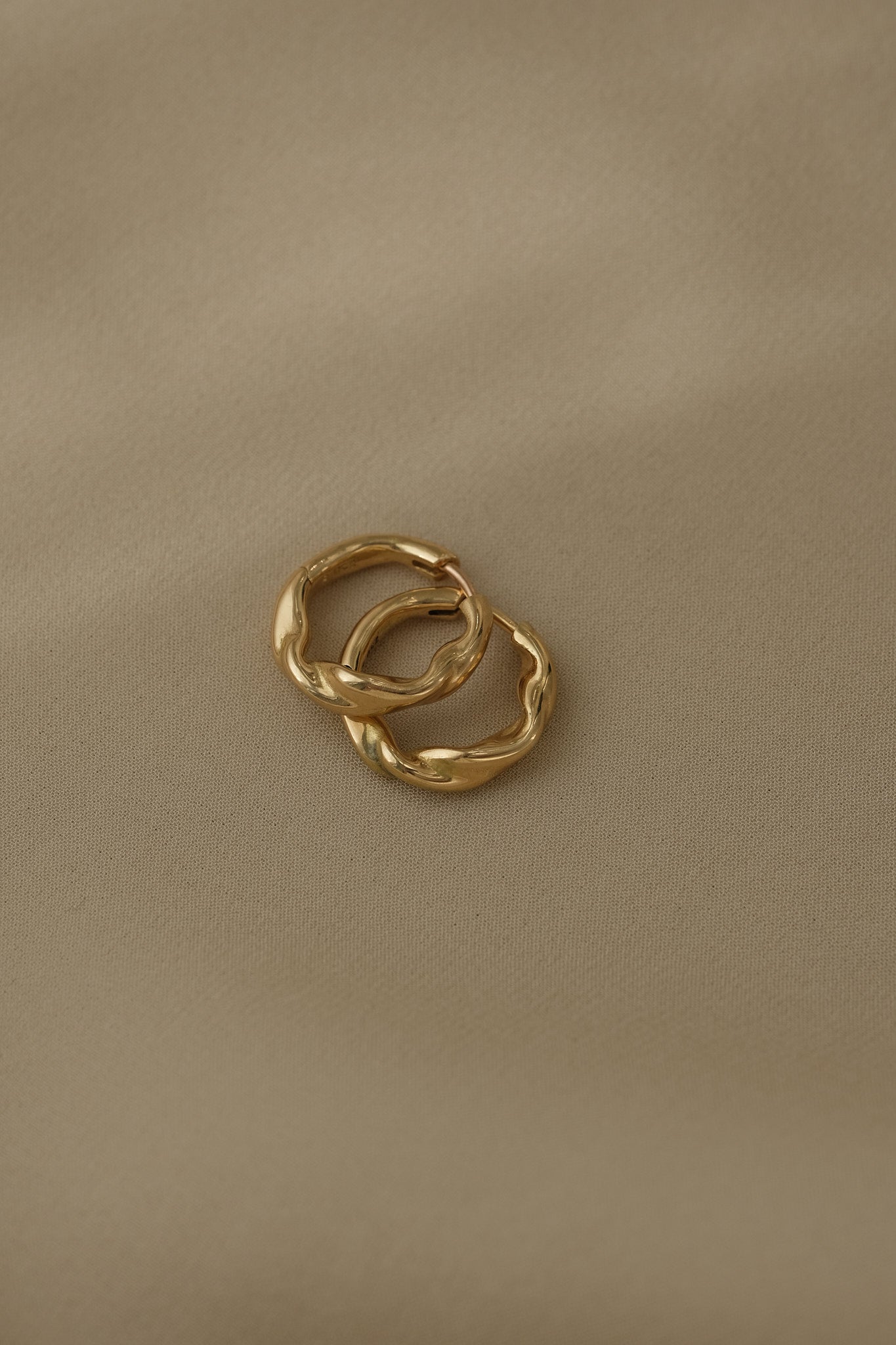 AGAPI hoops in 18k recycled gold from Basel, Switzerland, showcasing sustainable and local craftsmanship.