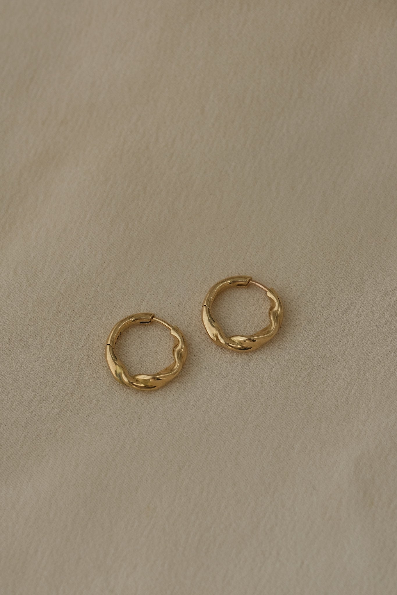 AGAPI hoops in 18k recycled gold, sustainable earrings designed and polished in Basel, Switzerland.