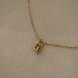 Handcrafted COESA necklace in 18k recycled gold from Basel, Switzerland, featuring a unique design with organic elements.