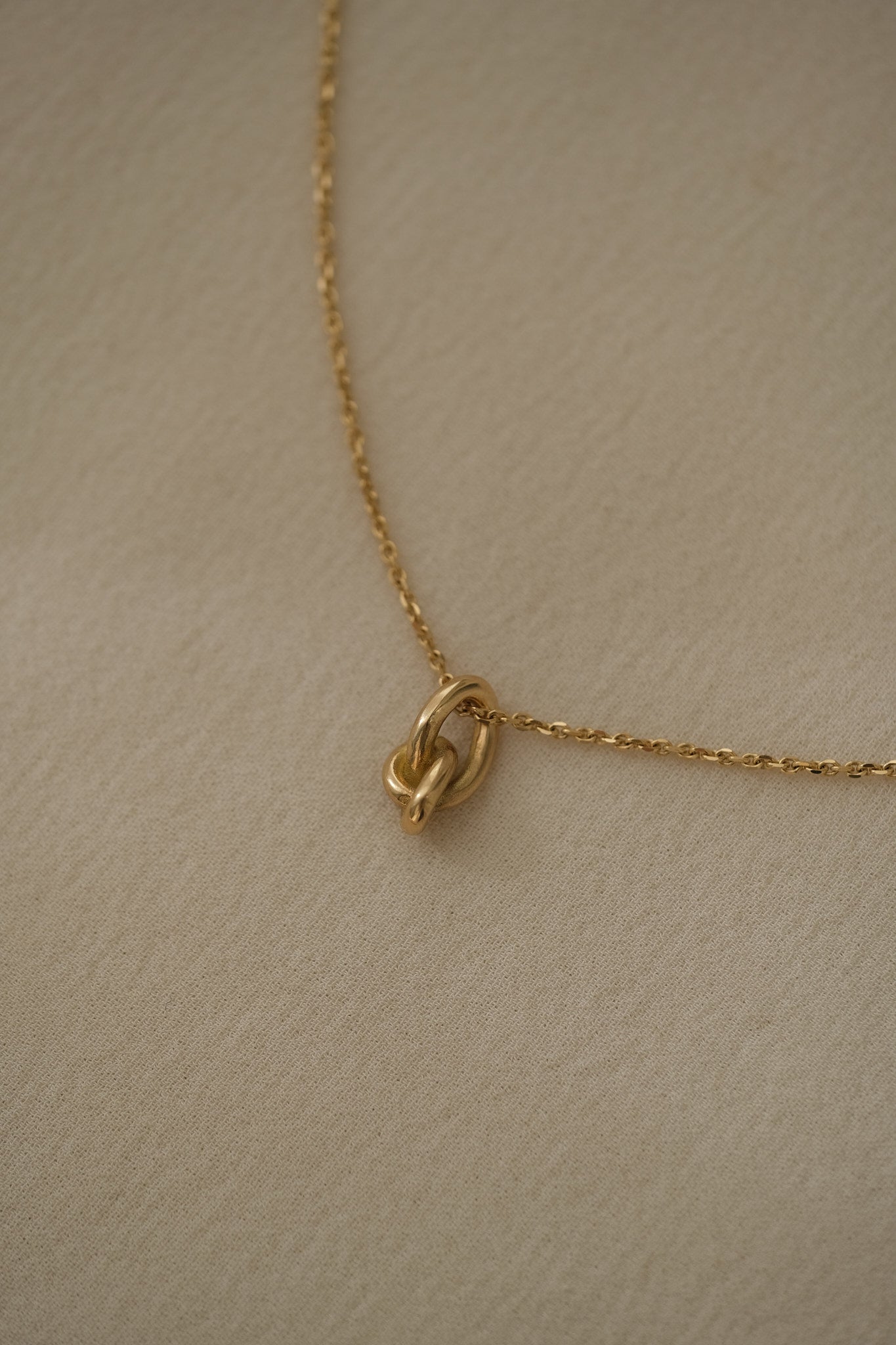 Handcrafted COESA necklace in 18k recycled gold from Basel, Switzerland, featuring a unique design with organic elements.