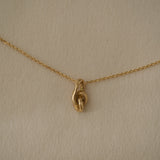 SINUOSA necklace in 18k recycled gold, handcrafted in Basel Switzerland, featuring a natural shiny surface.