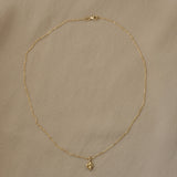 TOVE necklace in 18k recycled gold, handcrafted in Basel, featuring a delicate pendant on a thin chain.