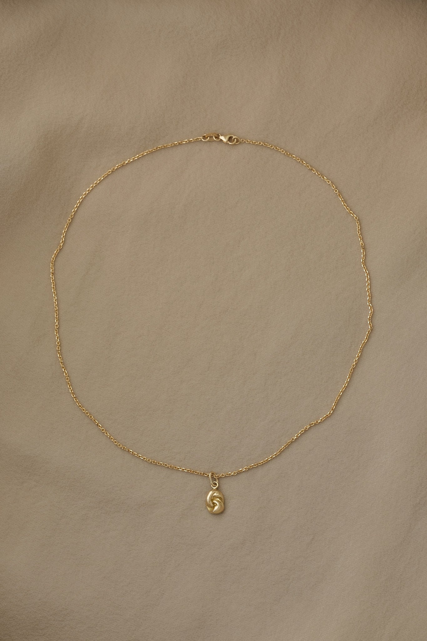 TWINE necklace in 18k recycled gold, handcrafted in Basel, featuring a delicate chain and organic pendant design.