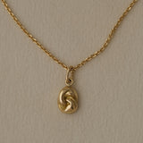 TWINE necklace in 18k recycled gold, handcrafted in Basel, featuring an organic pendant with COR chain.