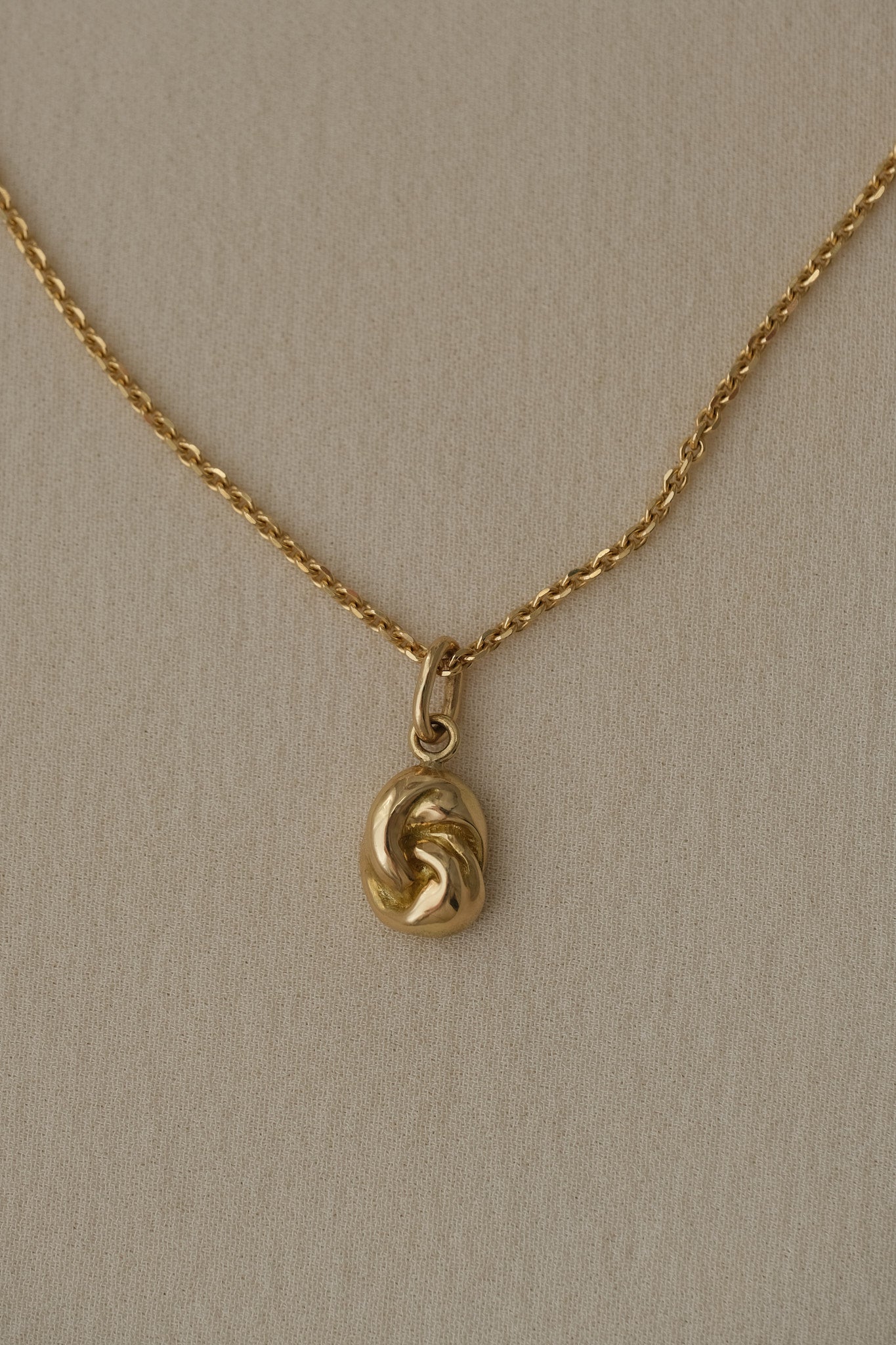 TWINE necklace in 18k recycled gold, handcrafted in Basel, featuring an organic pendant with COR chain.