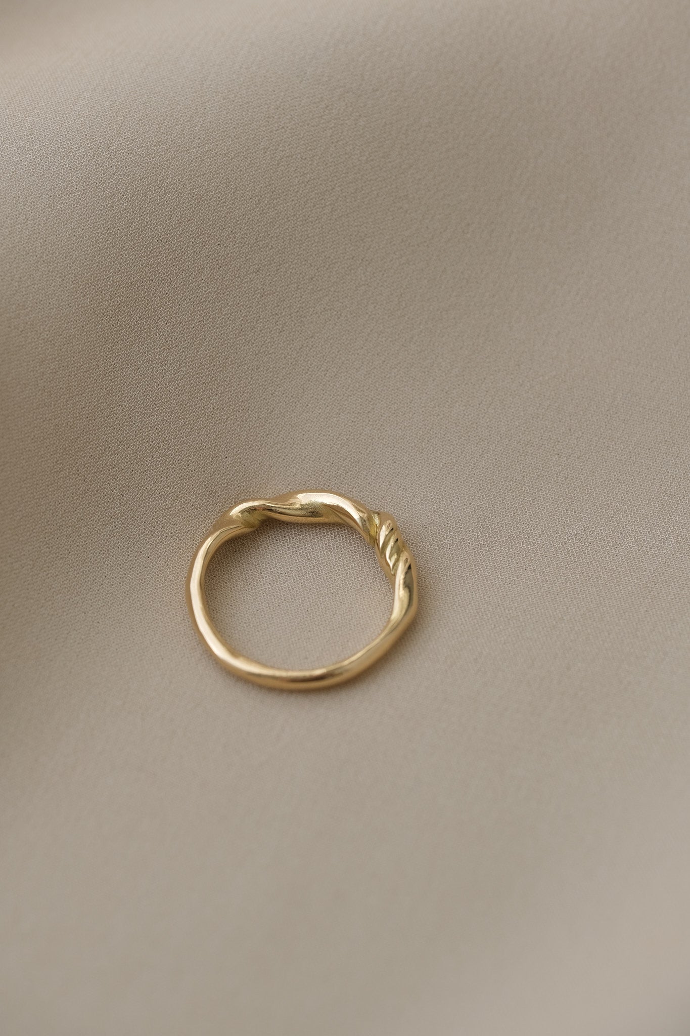 Handcrafted AGAPI ring in 18k recycled gold, featuring a natural shiny surface, designed in Basel, Switzerland.