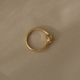 Handcrafted TWINE ring in 18k recycled gold, designed and polished in Basel, Switzerland, featuring a natural shiny surface.