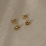 TOVE big studs in 18k recycled gold, handcrafted in Basel, Switzerland, showcasing an organic and shiny design.