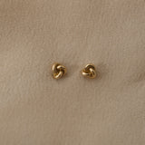 TOVE small studs in 18k recycled gold, handcrafted in Basel, Switzerland, featuring an organic design with a shiny surface.