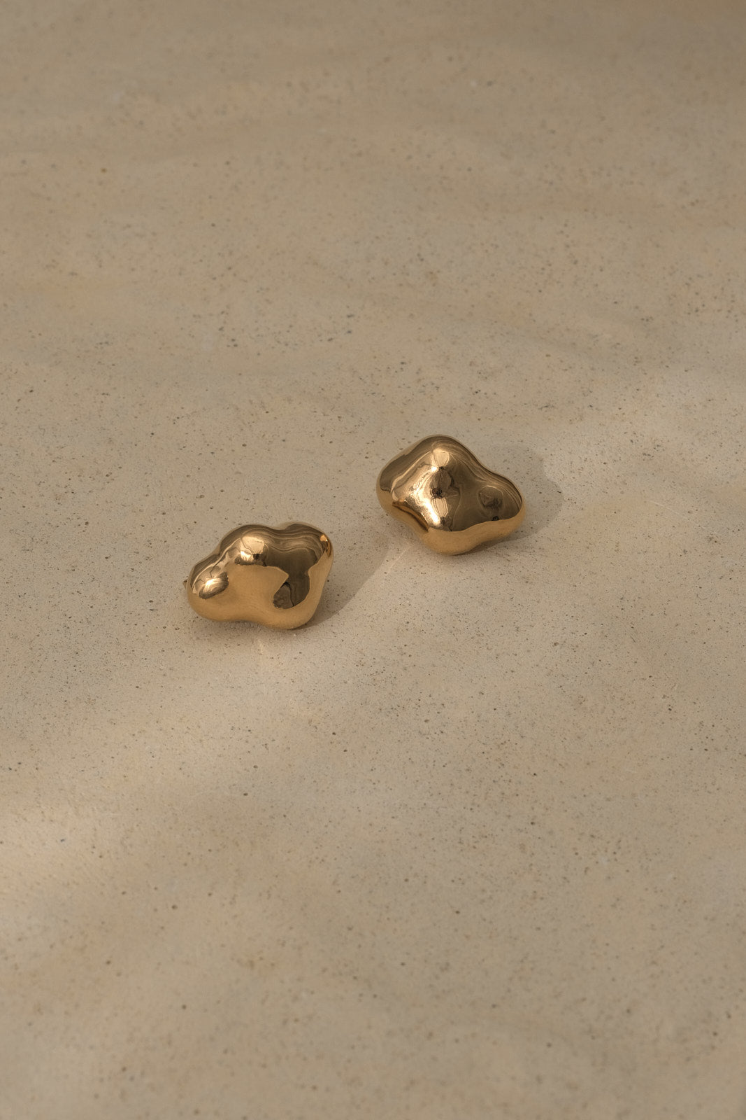 Handmade CLOUD earrings in 18k gold-plated recycled silver, showcasing a natural shiny finish, designed sustainably.