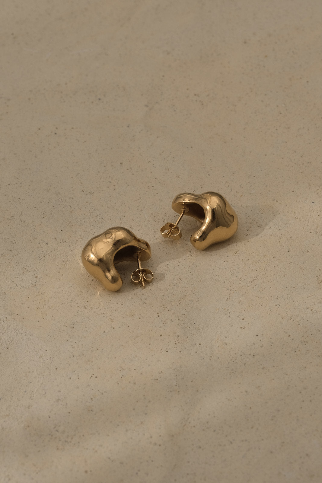 CLOUD earrings made of recycled gold with a natural shiny surface, designed in Basel, Switzerland, and ethically handcrafted.