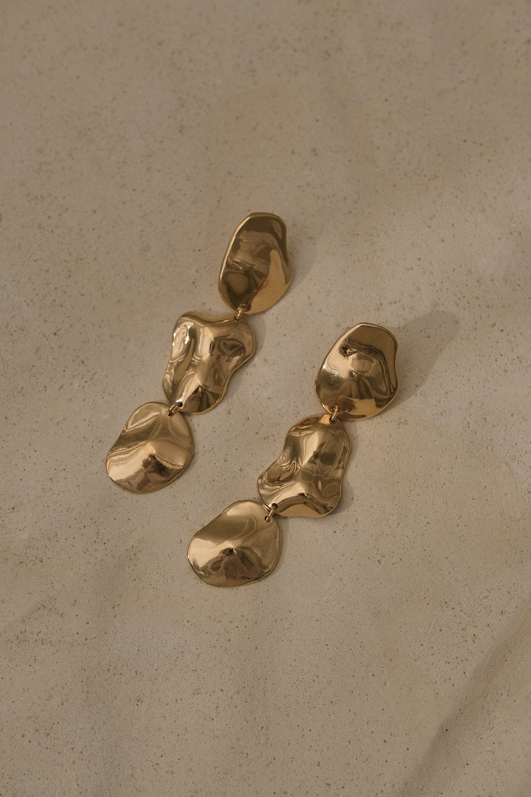 COSMA earrings in recycled gold, handmade ethical jewelry with a natural shiny surface, designed in Switzerland.