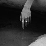 Hand adorned with DUNA ring, showcasing ethical jewelry made from recycled silver and gold.