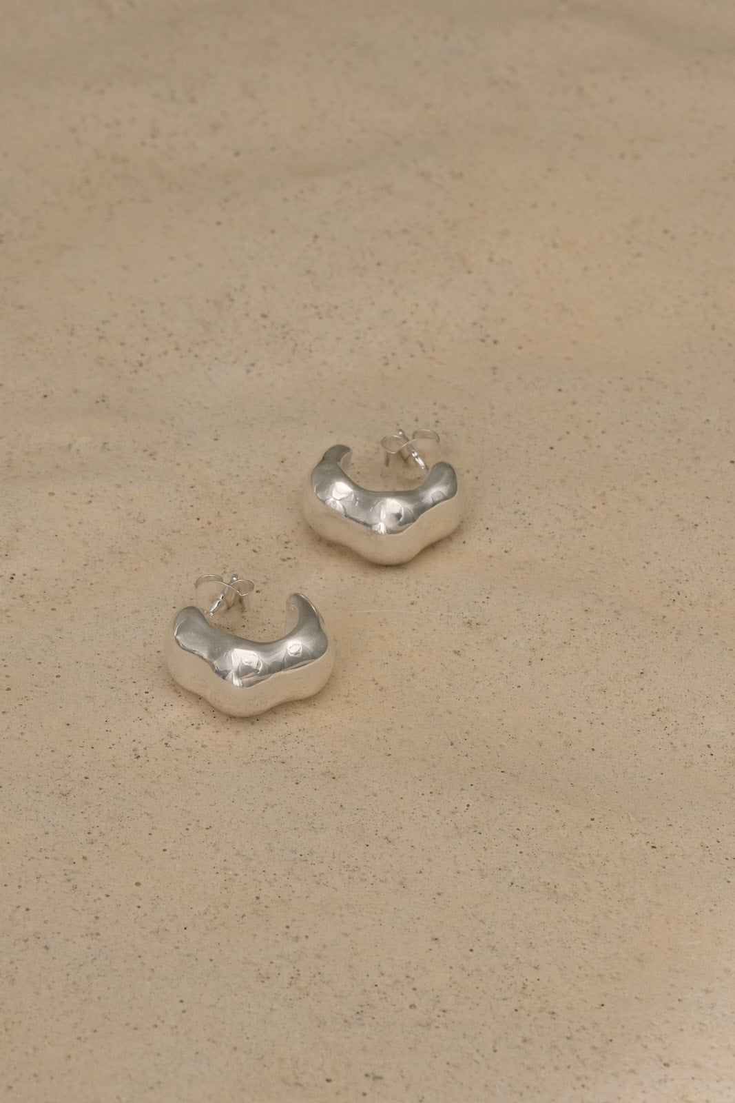 FLUID earrings made from recycled silver, showcasing sustainable and ethical handmade jewelry with a natural shiny finish.