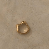 Ethical handmade FLUID ring in 18k gold-plated recycled silver on a neutral background.