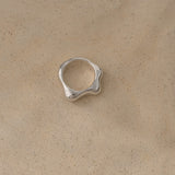 Handmade FLUID ring in recycled silver, showcasing a natural shiny surface, emphasizing ethical and sustainable jewelry.