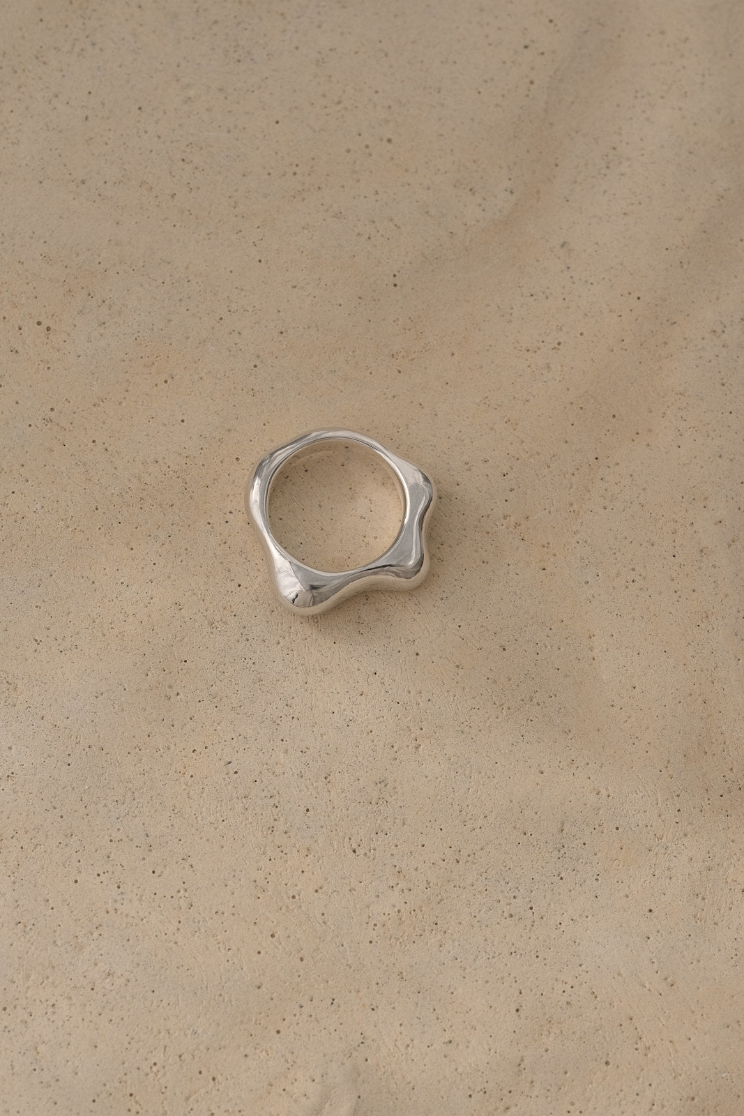 Handmade FLUID ring in recycled silver, showcasing a natural shiny surface, emphasizing ethical and sustainable jewelry.