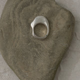 HALO ring in 925 recycled silver resting on a smooth stone, highlighting its sustainable and high-quality design.