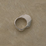 HALO ring in recycled 925 silver, showcasing a natural shiny surface on a subtle textured background.