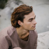 Man wearing a MISMO earcuff made from recycled silver, showcasing ethical, handmade, and sustainable fashion.
