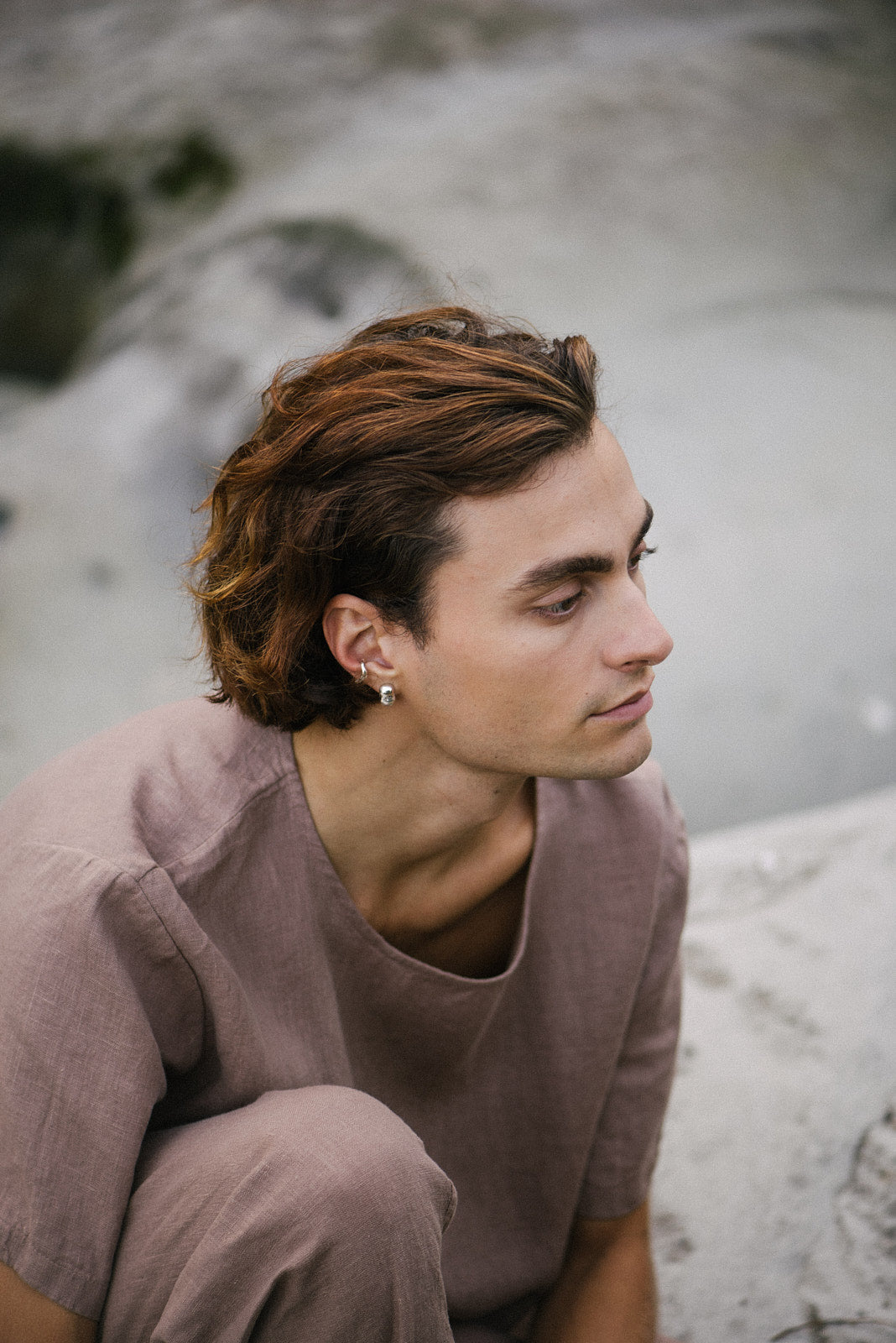 Man wearing a MISMO earcuff made from recycled silver, showcasing ethical, handmade, and sustainable fashion.