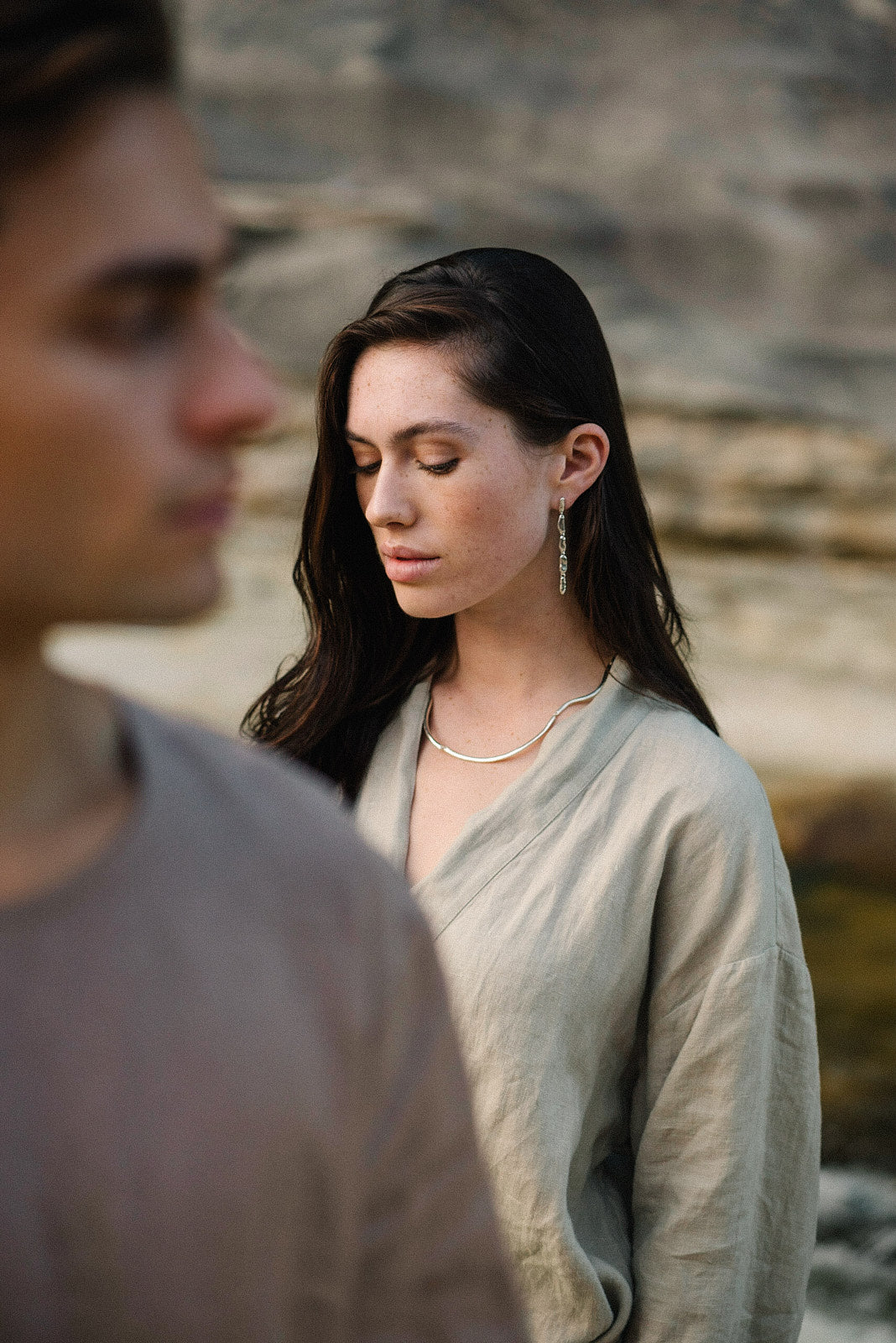 MURMUR earrings worn by a woman in a natural setting, highlighting ethical jewelry craftsmanship and sustainable materials.