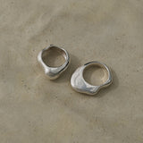 Two unique HALO rings crafted from 925 recycled silver with a shiny polished finish on a neutral background.
