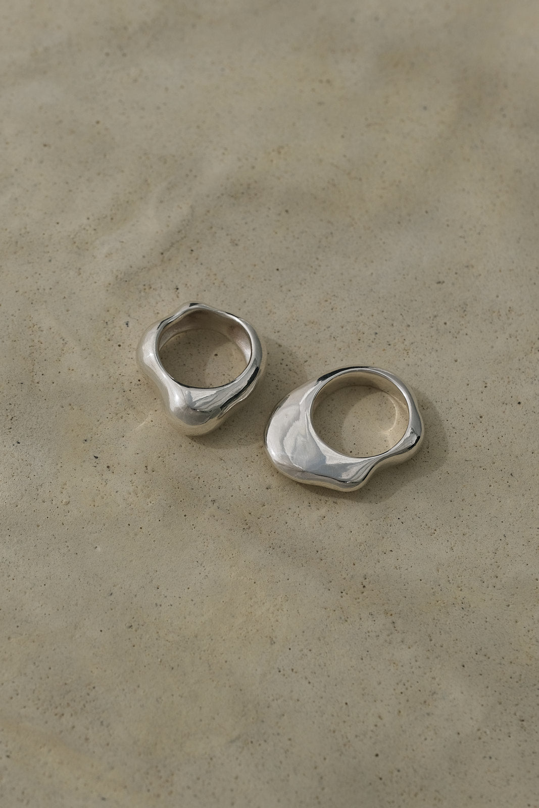 Two unique HALO rings crafted from 925 recycled silver with a shiny polished finish on a neutral background.