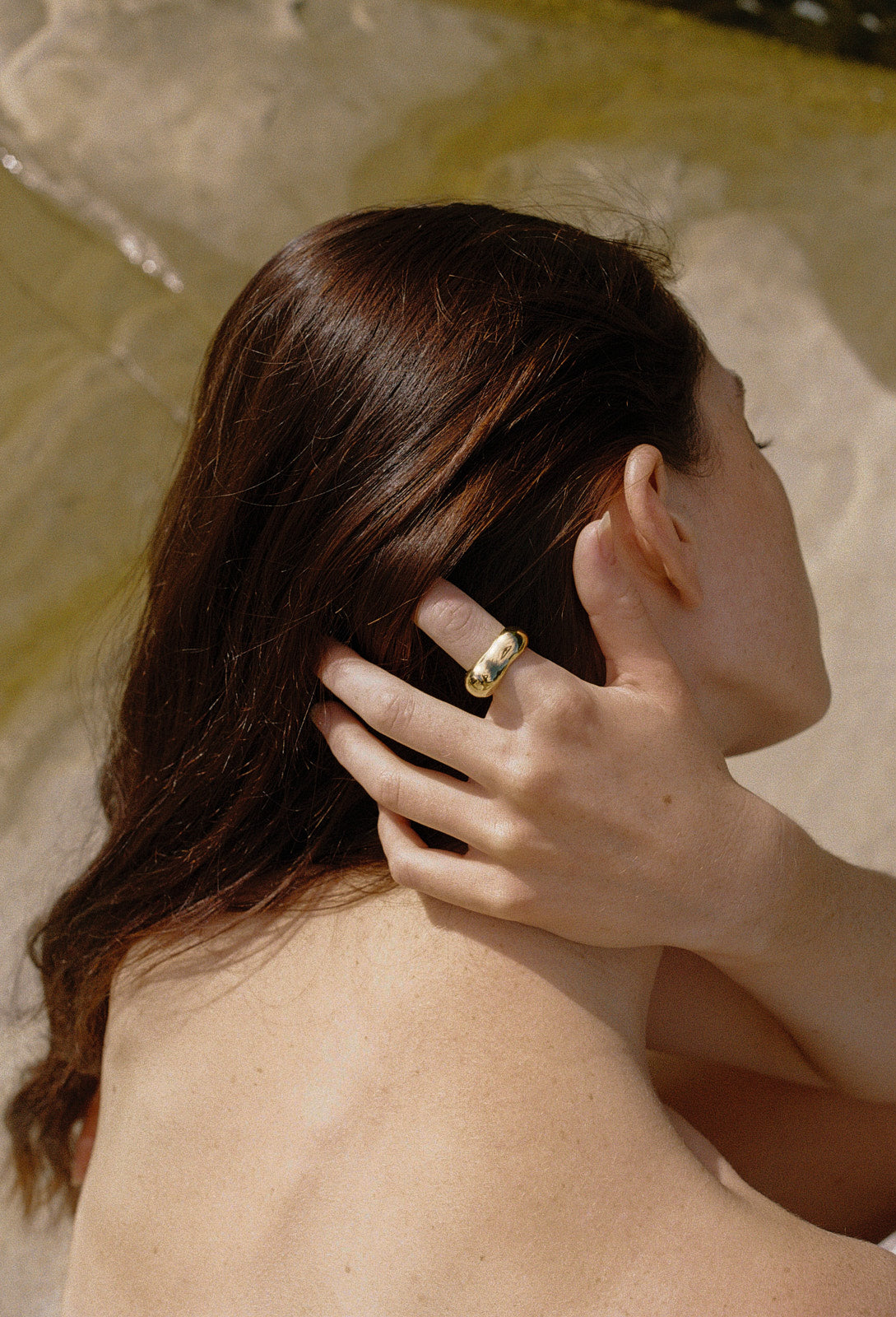 MUSA ring on model's hand, showcasing ethical jewelry made from recycled gold and silver.