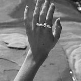 Hand displaying the MUSA ring, showcasing ethical, handmade jewelry in recycled silver.
