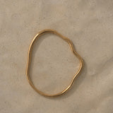 Handmade PLACID bangle in 18k gold-plated recycled silver, showcasing ethical craftsmanship and sustainable materials.