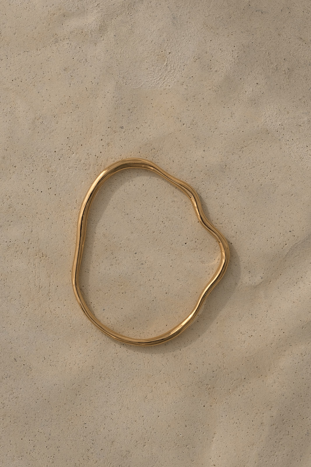 Handmade PLACID bangle in 18k gold-plated recycled silver, showcasing ethical craftsmanship and sustainable materials.