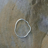 Handcrafted PLACID bangle made from recycled silver, highlighting ethical jewelry and sustainable design.