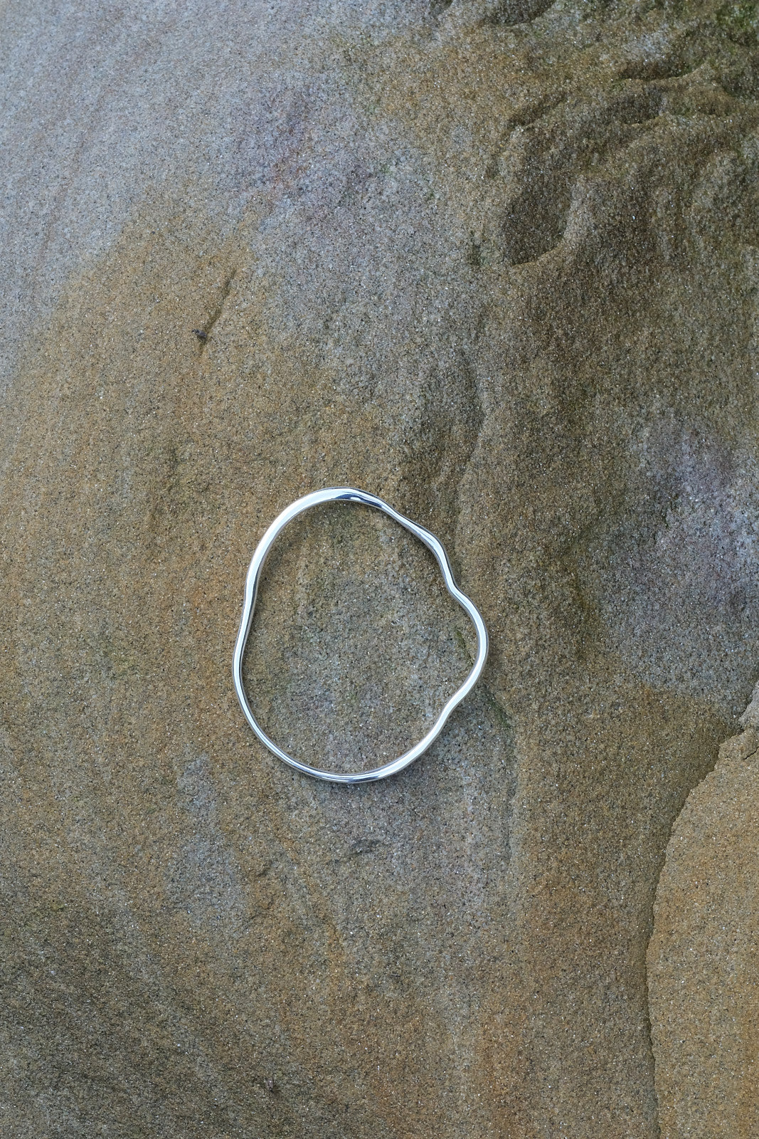 Handcrafted PLACID bangle made from recycled silver, highlighting ethical jewelry and sustainable design.