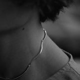 Close-up of a person wearing a PLACID necklace made from 925 recycled silver, showcasing ethical handmade jewelry.