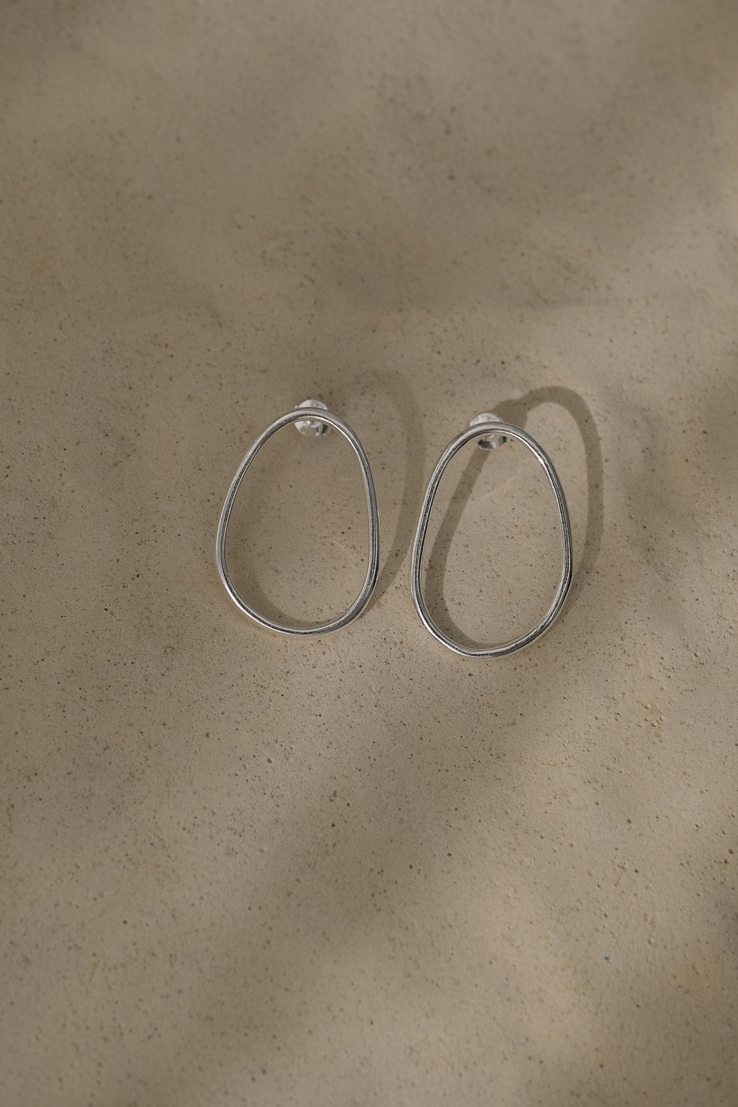 Handmade LOON big earrings in recycled silver with a natural finish. Ethical and sustainable jewelry design.