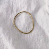 Handcrafted LOON bangle in 18k recycled gold, with a semi-shiny finish, designed in Basel, Switzerland.