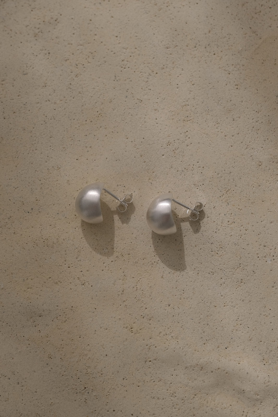 ONOA earrings made of recycled silver, showcasing ethical and sustainable handmade jewelry with a semi-matte finish.